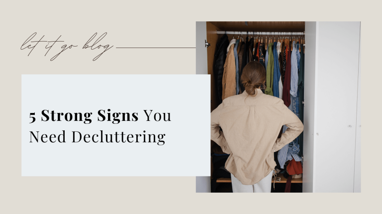 Woman standing in front of an open wardrobe, thinking about decluttering her clothes – 5 strong signs you need decluttering.